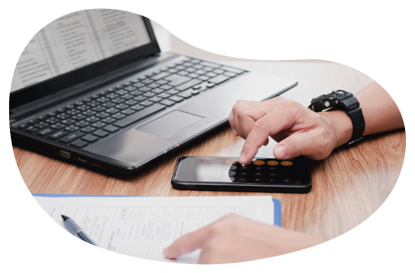 An IT professional calculates insurance costs using a smartphone and clipboard.